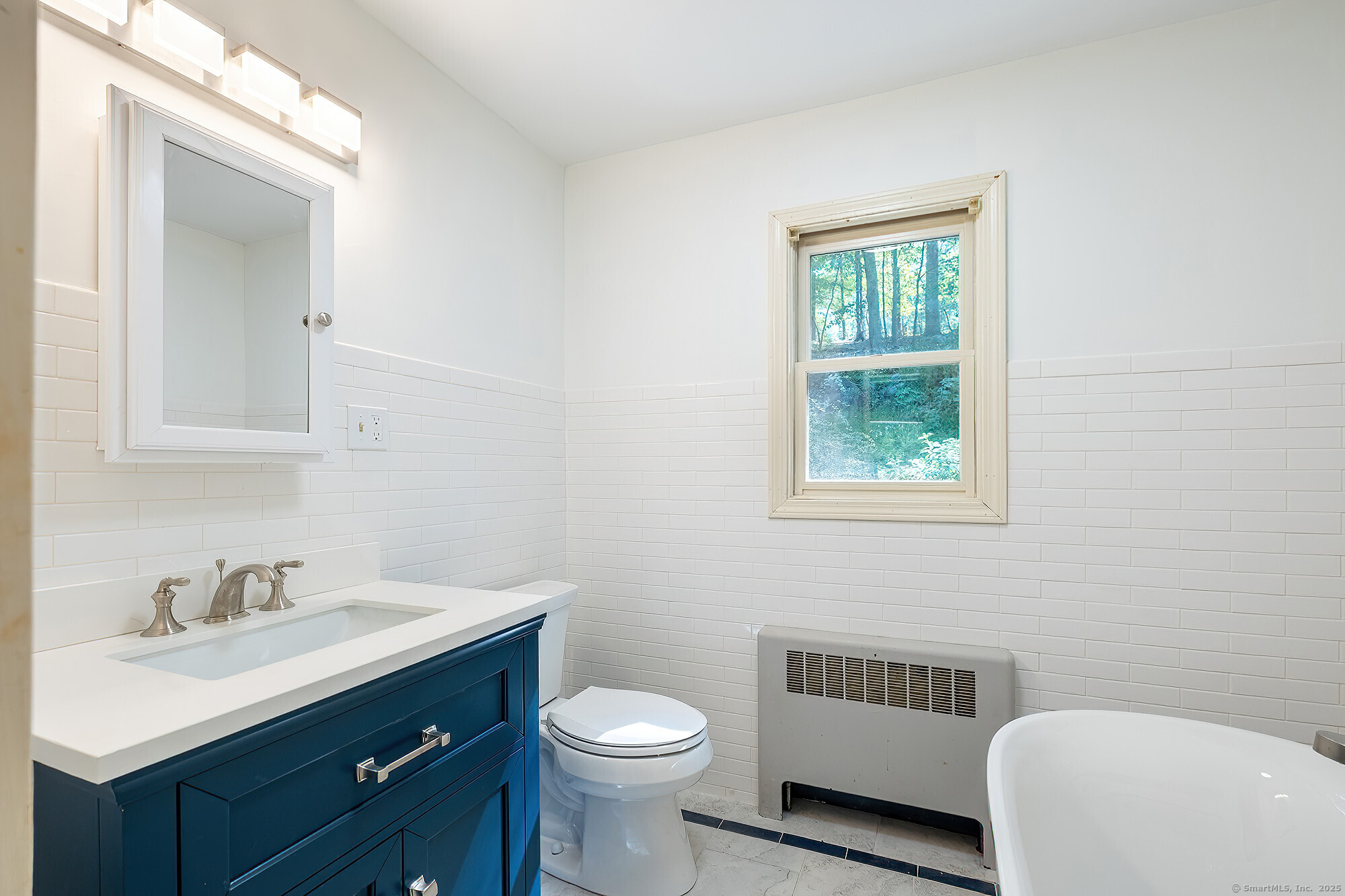 15 Laurel Hill Road Ridgefield, CT 06877 - Photo 14 of 34 a bathroom with a sink toilet a mirror and vanity