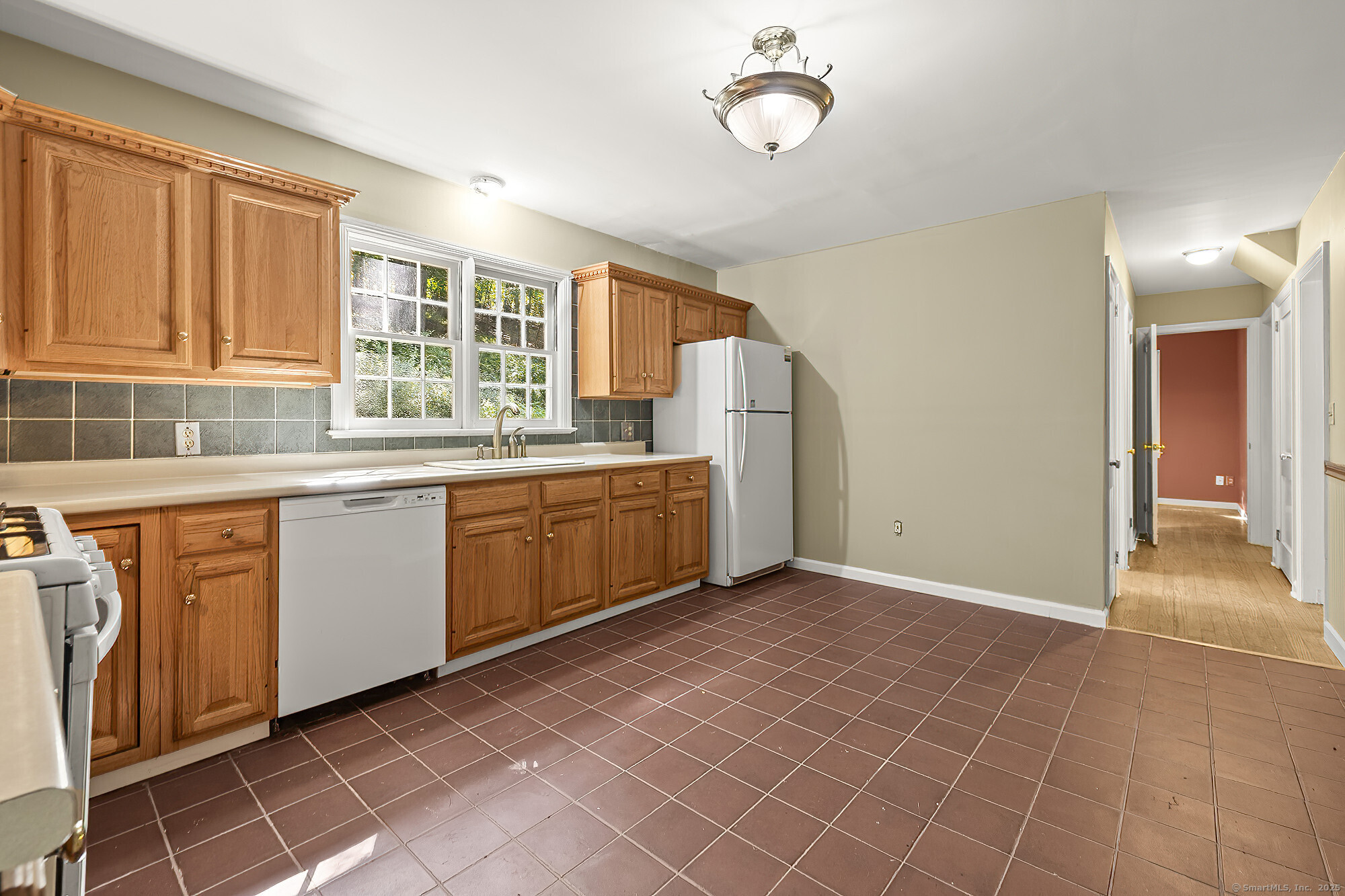 15 Laurel Hill Road Ridgefield, CT 06877 - Photo 4 of 34 a kitchen with a sink a stove cabinets and wooden floor