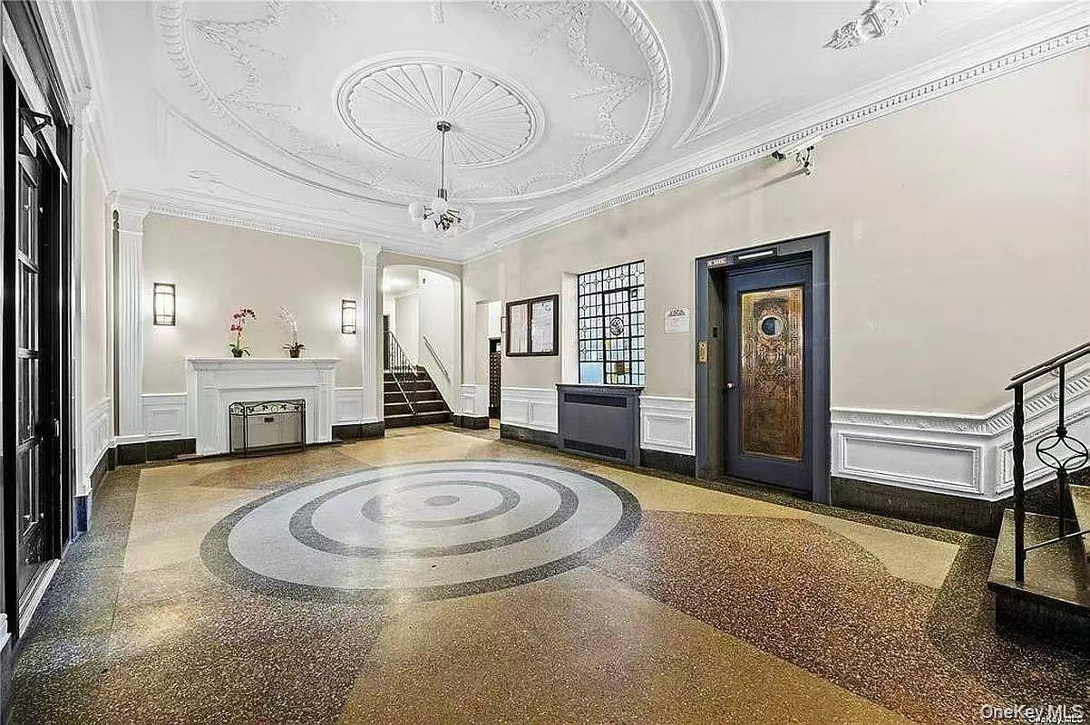 40-35 Ithaca Street, Unit 5B Queens, NY 11373 - Photo 3 of 10 Lobby featuring a decorative wall, ornamental molding, stairs, and wainscoting