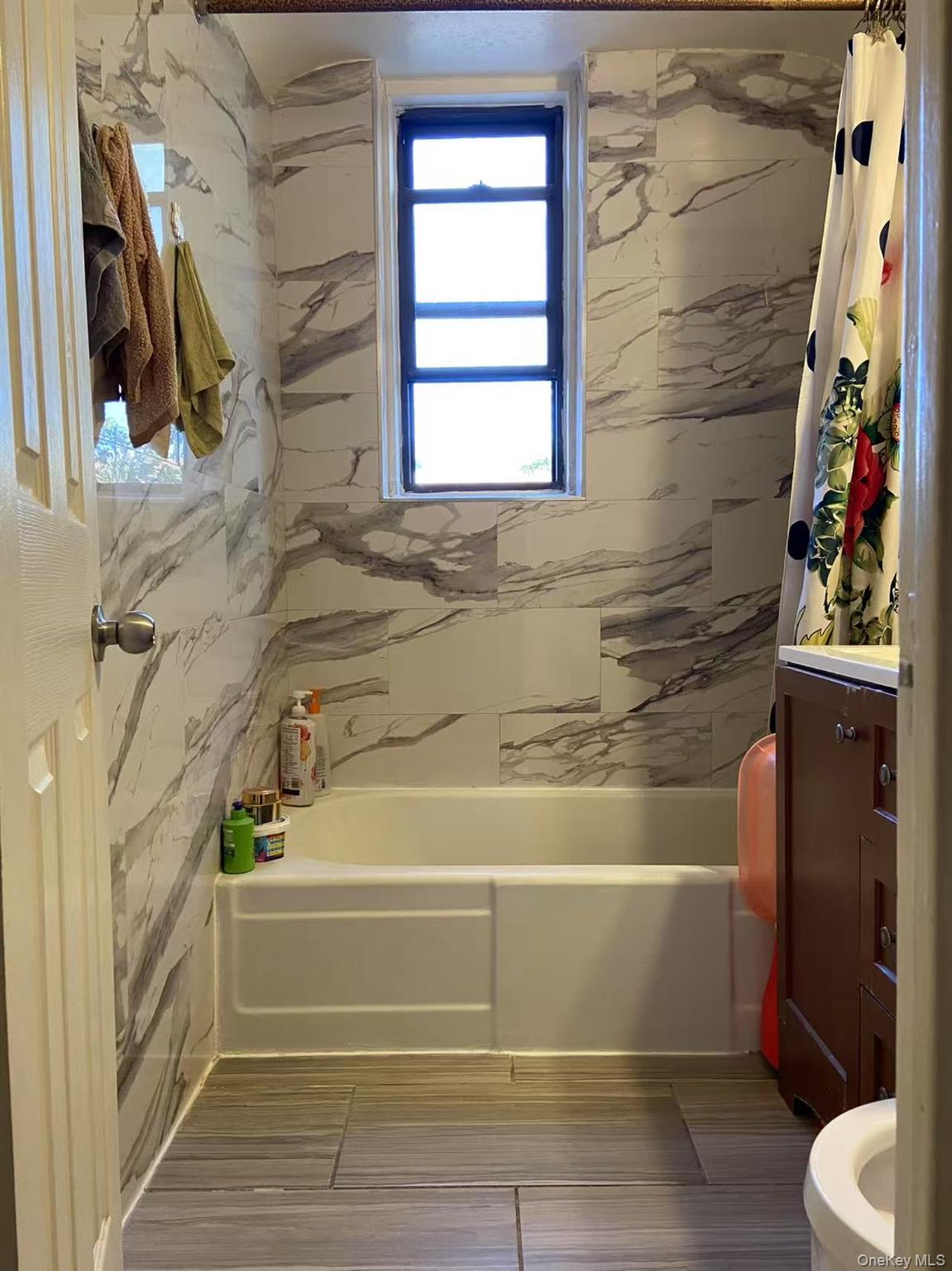 40-35 Ithaca Street, Unit 5B Queens, NY 11373 - Photo 4 of 10 Full bathroom featuring shower / tub combo with curtain and vanity