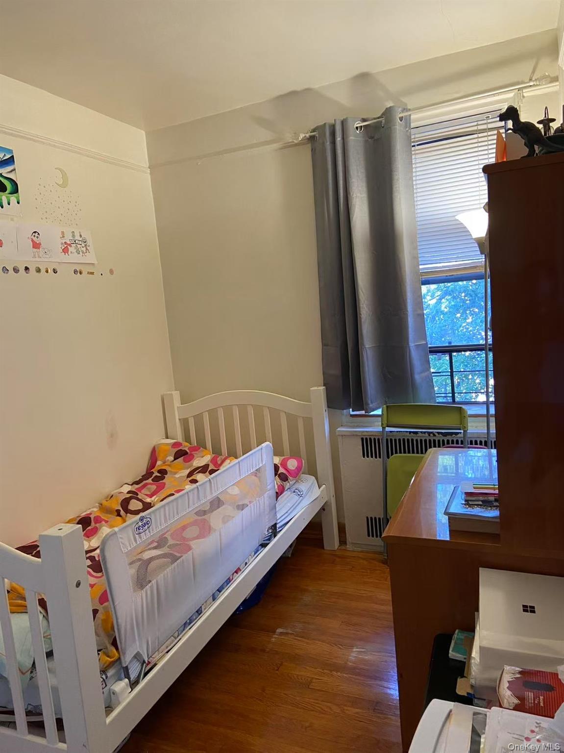 40-35 Ithaca Street, Unit 5B Queens, NY 11373 - Photo 8 of 10 Bedroom featuring wood finished floors and radiator heating unit
