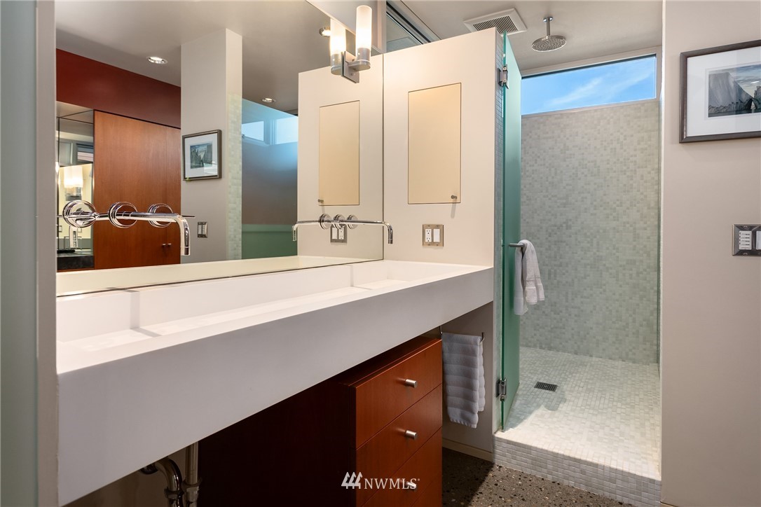 2369 Fairview Avenue East, Unit 6 Seattle, WA 98102 - Photo 16 of 26 a bathroom with a shower sink and mirror