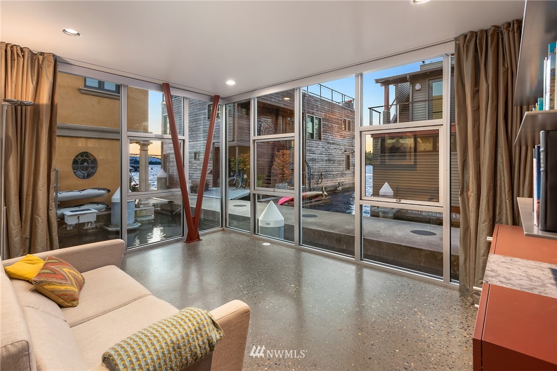 2369 Fairview Avenue East, Unit 6 Seattle, WA 98102 - Photo 18 of 26 a living room with furniture a flat screen tv and a refrigerator