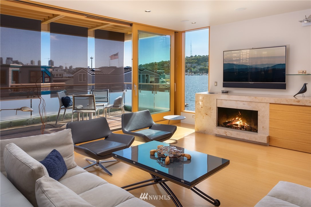 2369 Fairview Avenue East, Unit 6 Seattle, WA 98102 - Photo 4 of 26 a living room with furniture a flat screen tv and a fireplace