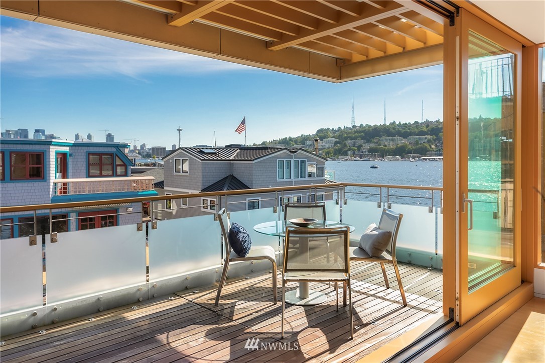 2369 Fairview Avenue East, Unit 6 Seattle, WA 98102 - Photo 5 of 26 a view of a balcony with chairs and wooden floor
