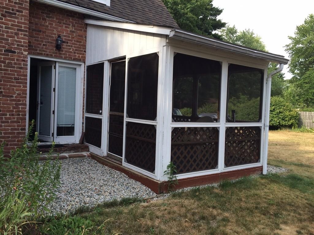 65 Peekskill Avenue Springfield, MA 01129 - Photo 12 of 12 a view of backyard with large window and wooden fence