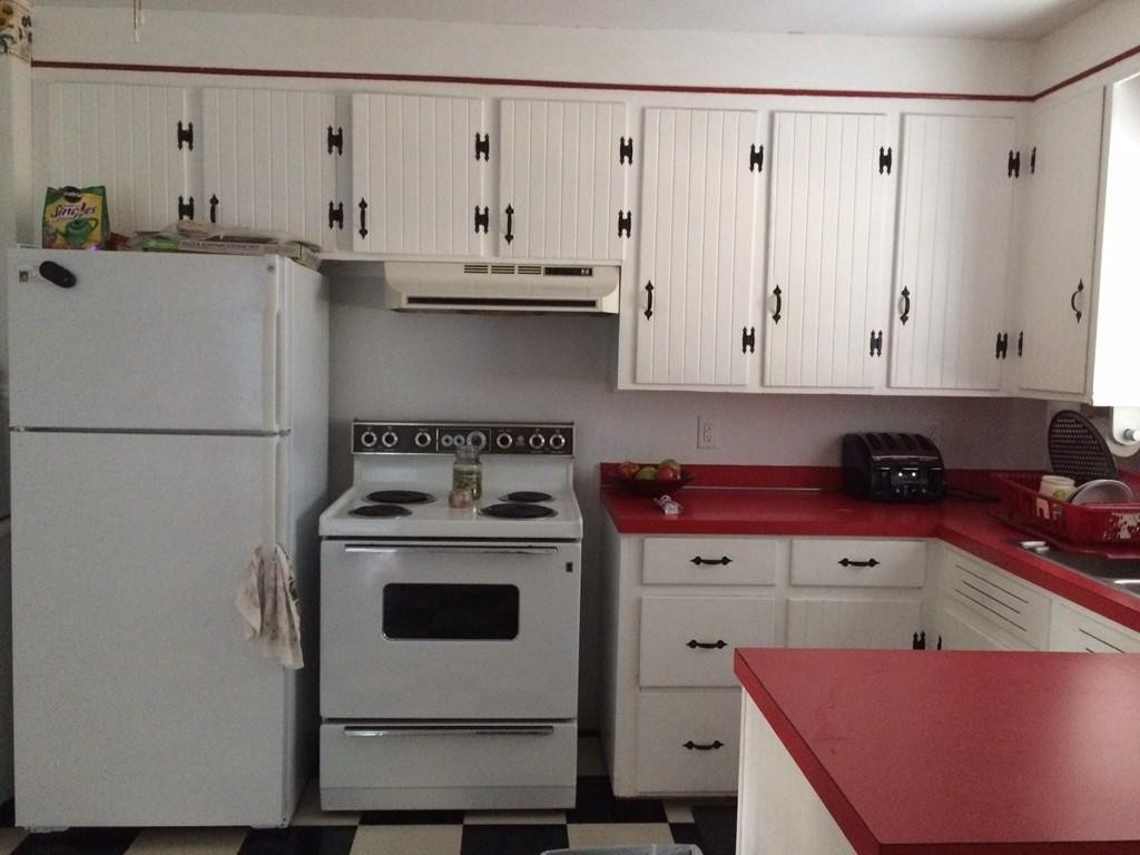 65 Peekskill Avenue Springfield, MA 01129 - Photo 3 of 12 a kitchen with stainless steel appliances granite countertop a refrigerator a stove and white cabinets