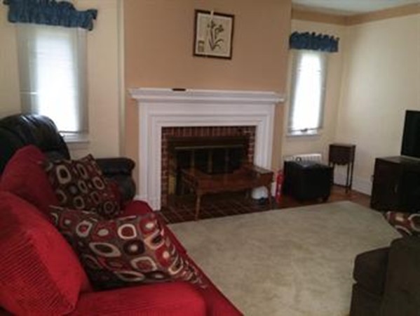 65 Peekskill Avenue Springfield, MA 01129 - Photo 7 of 12 a living room with furniture and a fireplace