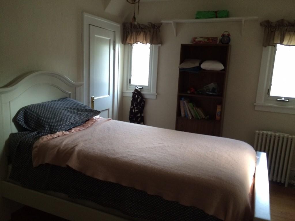 65 Peekskill Avenue Springfield, MA 01129 - Photo 10 of 12 a bedroom with a bed and a window