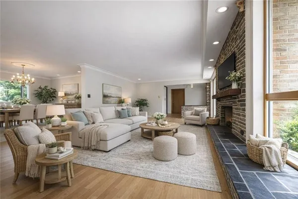 a living room with furniture large window and a fireplace