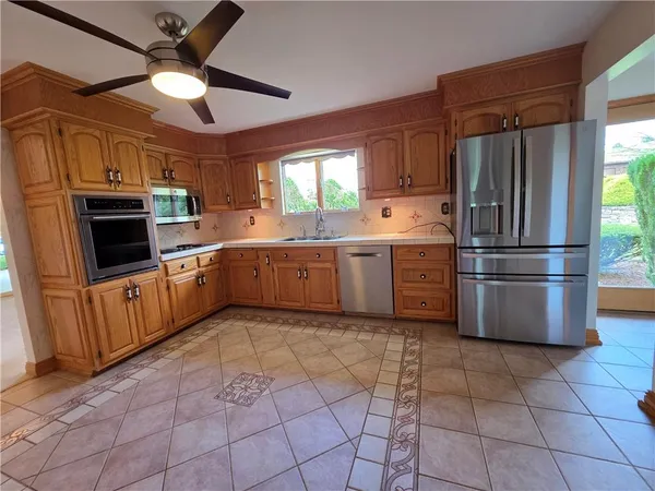 a kitchen with granite countertop a refrigerator and a sink