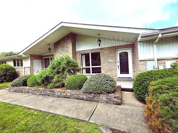 a front view of a house with garden