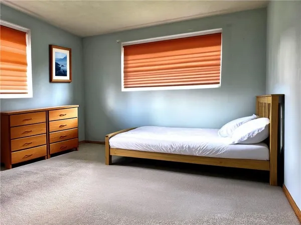 a bedroom with bed and a window