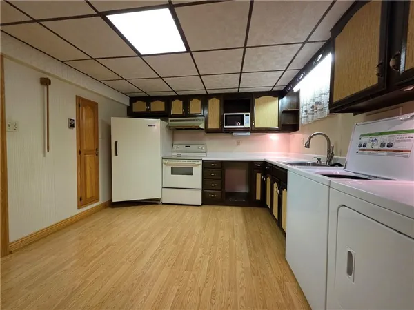 a kitchen with stainless steel appliances granite countertop a sink a stove top oven a counter space and cabinets