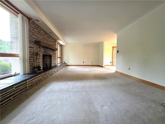 a view of an empty room with a fireplace
