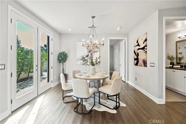 a kitchen with granite countertop a refrigerator a stove top oven a sink and cabinets