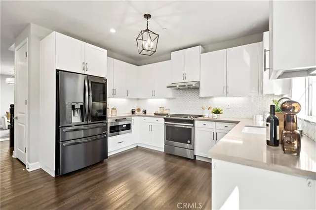 a kitchen with a refrigerator stove and sink