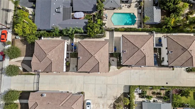 an aerial view of a house with a yard