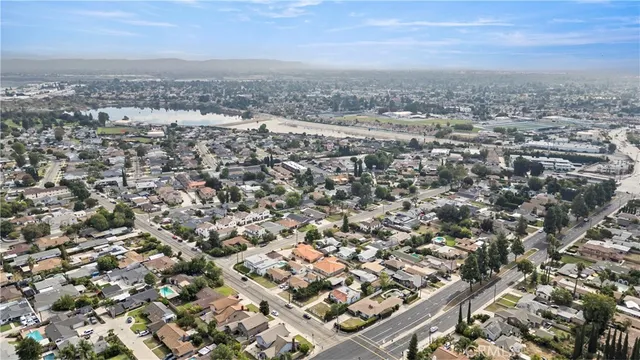 a living room with furniture a clock and a large window