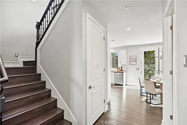 a bathroom with a granite countertop toilet a sink a mirror and a shower