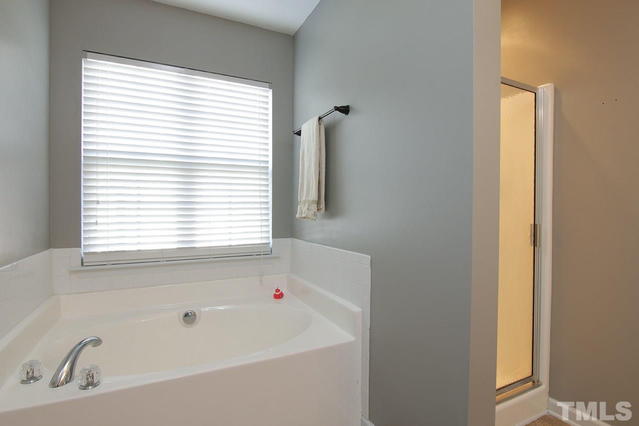 9820 Layla Avenue Raleigh, NC 27617 - Photo 11 of 17 a white bath tub sitting next to a window