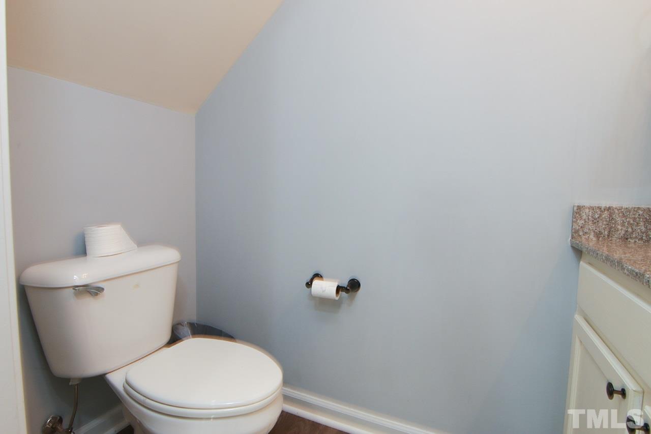 9820 Layla Avenue Raleigh, NC 27617 - Photo 17 of 17 a white toilet sitting next to a white wall