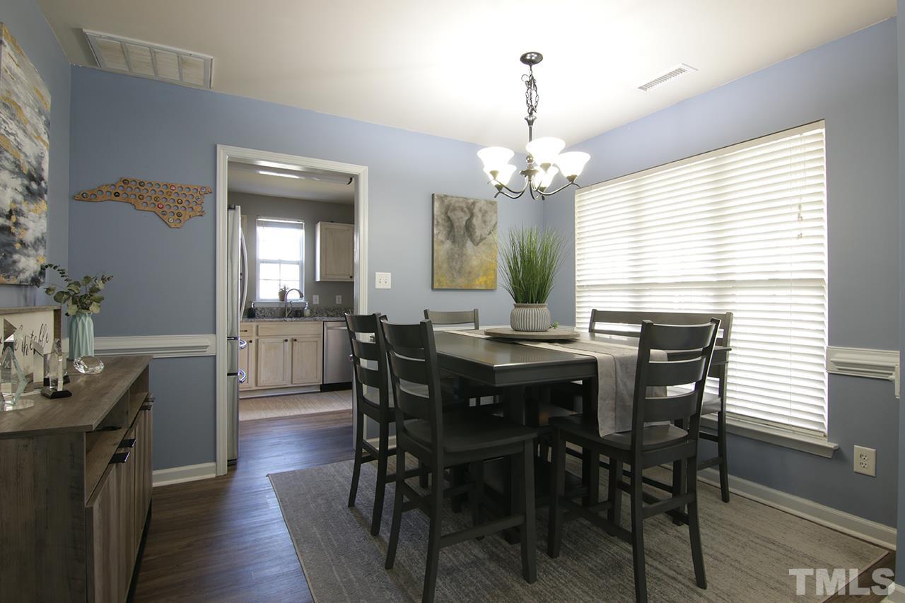 9820 Layla Avenue Raleigh, NC 27617 - Photo 4 of 17 a view of a dining room with furniture and wooden floor