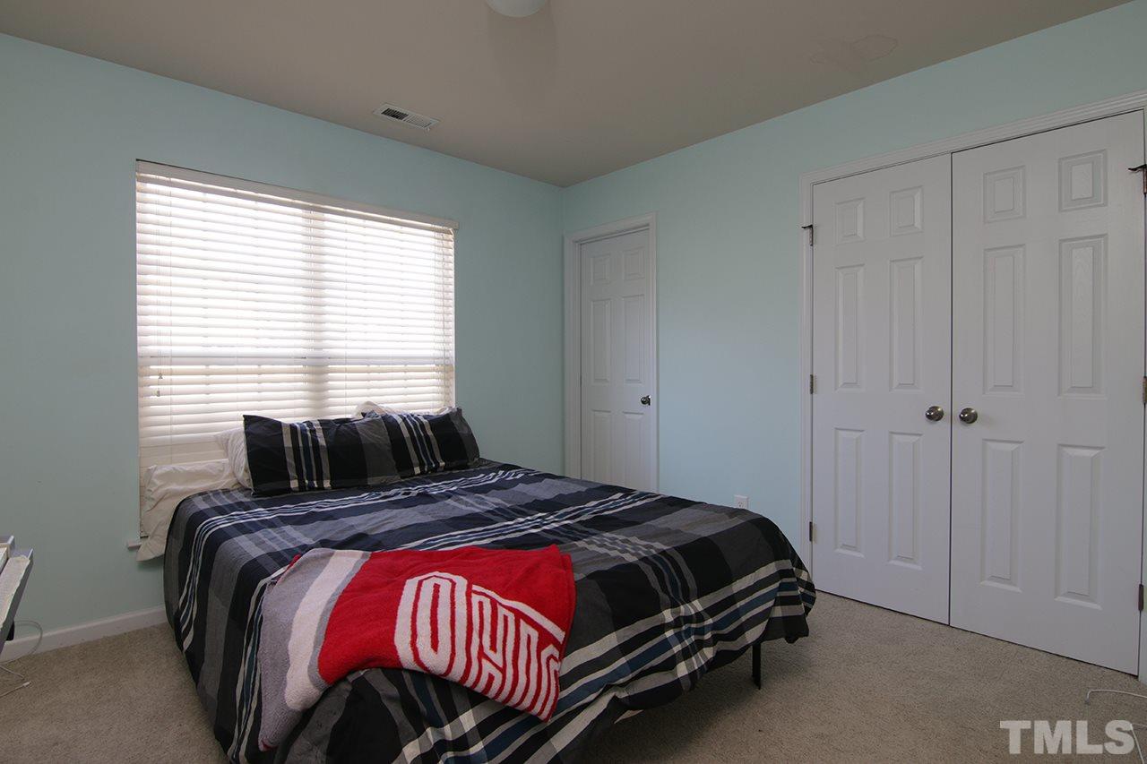 9820 Layla Avenue Raleigh, NC 27617 - Photo 5 of 17 a bedroom with a bed and window