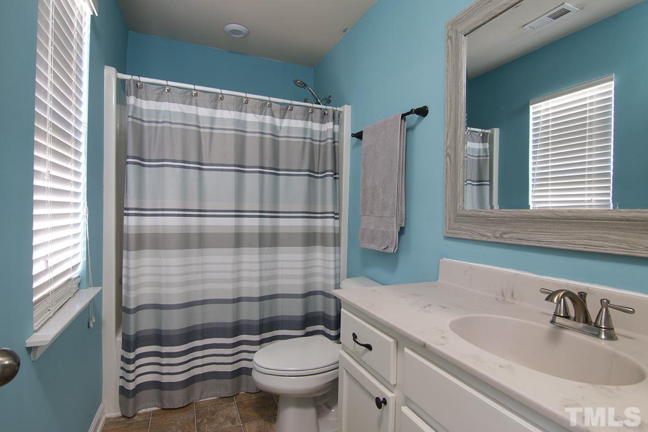 9820 Layla Avenue Raleigh, NC 27617 - Photo 7 of 17 a bathroom with a sink toilet and shower