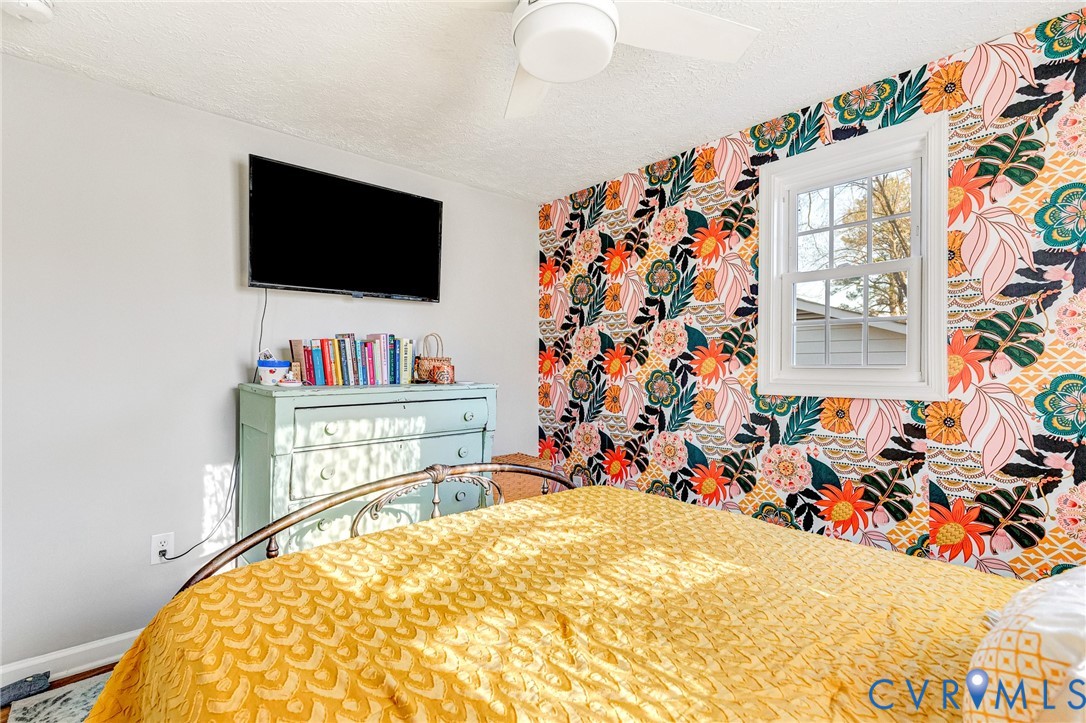 16004 Gary Avenue Chester, VA 23831 - Photo 15 of 26 a bed room with a bed and a flat screen tv