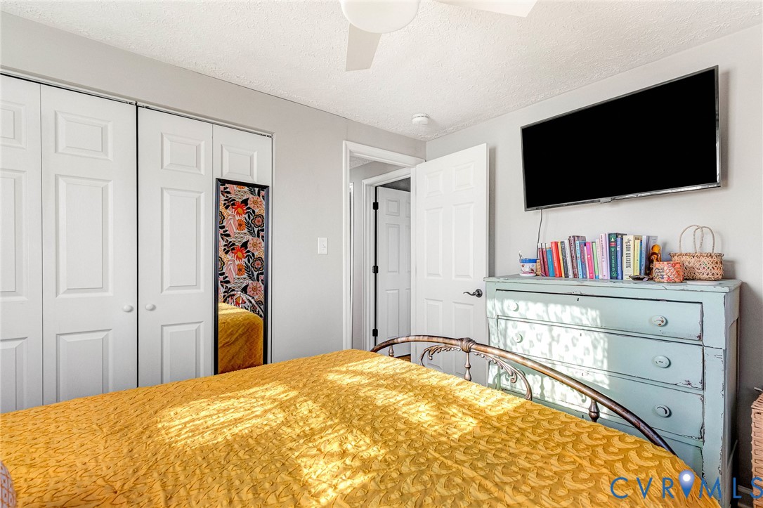 16004 Gary Avenue Chester, VA 23831 - Photo 16 of 26 a bedroom with a bed and a flat screen tv