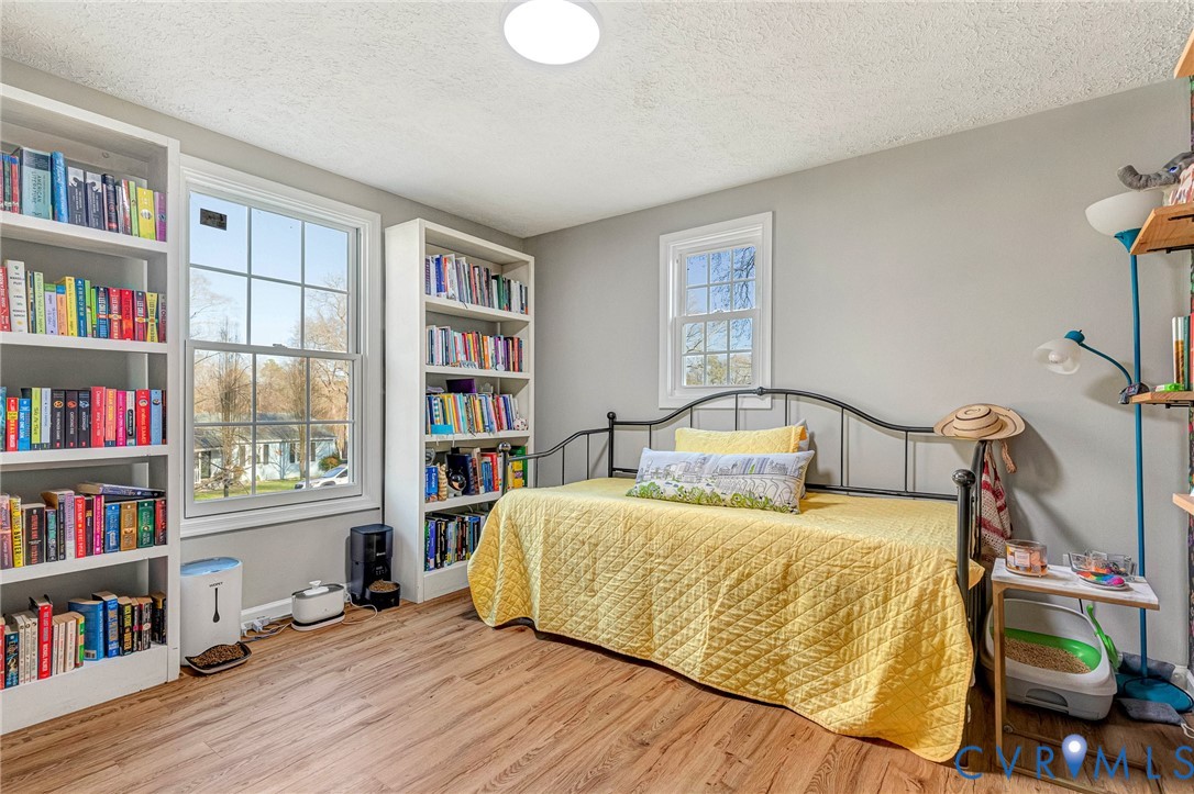 16004 Gary Avenue Chester, VA 23831 - Photo 17 of 26 a bedroom with a bed and a book shelf