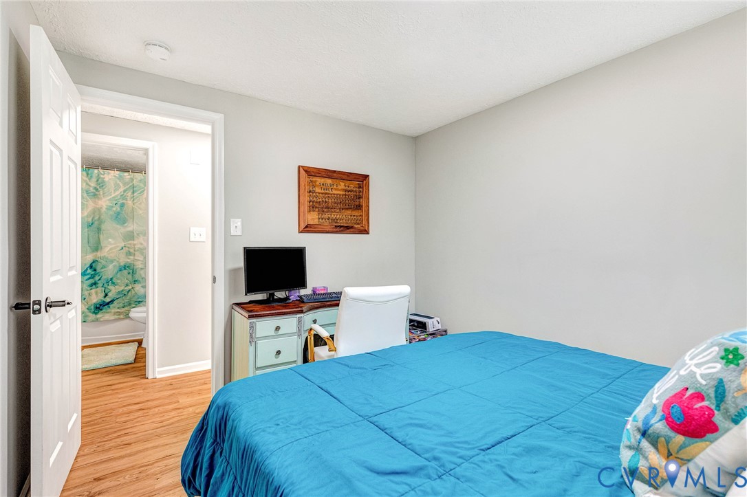 16004 Gary Avenue Chester, VA 23831 - Photo 19 of 26 a bedroom with a bed and a computer on a table