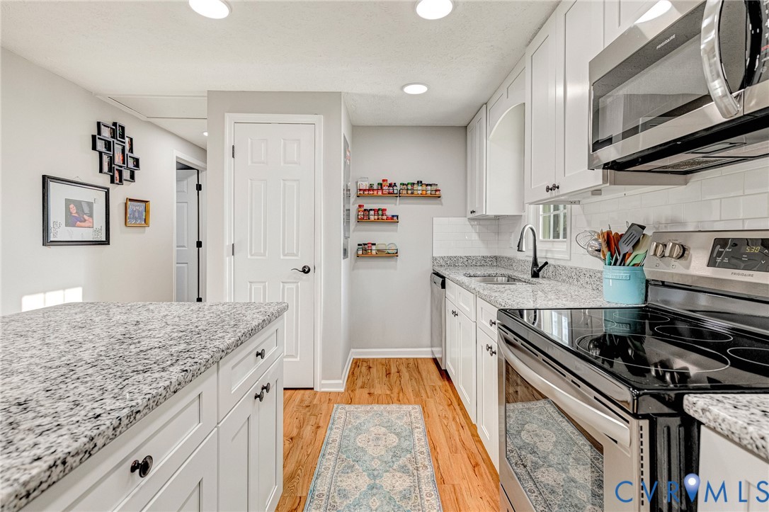 16004 Gary Avenue Chester, VA 23831 - Photo 6 of 26 a kitchen with stainless steel appliances granite countertop a stove and a sink