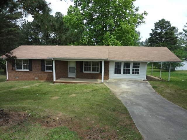 5355 Mulberry Rock Road Dallas, GA 30157 - Photo 1 of 1 a front view of a house with a garden