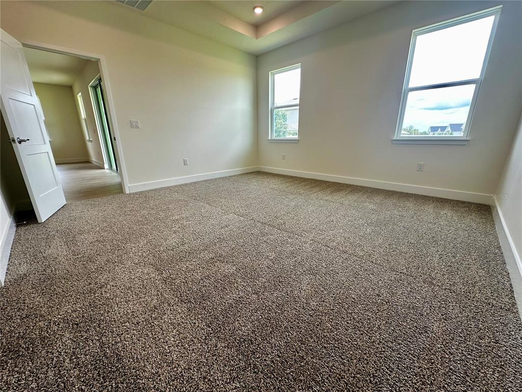 4281 Southwest 52nd Lane Road Ocala, FL 34474 - Photo 24 of 26 an empty room with a fireplace and windows