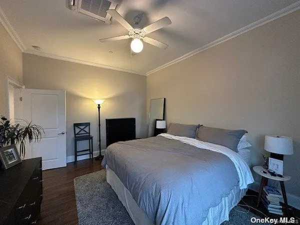 a spacious bedroom with a bed and a chandelier