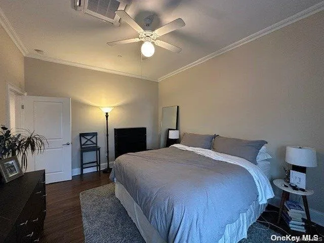 a spacious bedroom with a bed and a chandelier