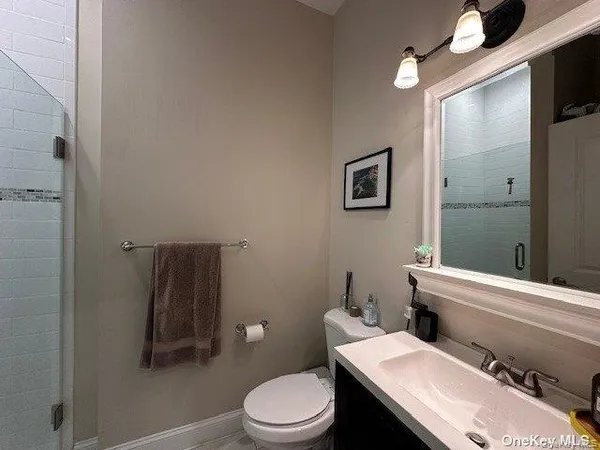 a white toilet sitting next to a bathroom sink