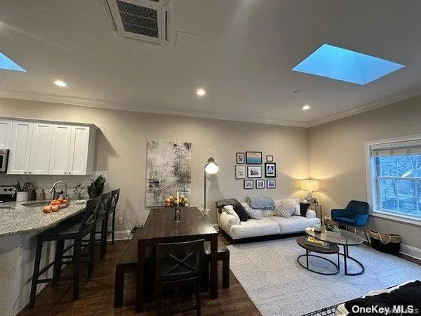 a living room with furniture a rug and a table