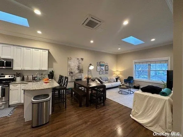 a living room with lots of furniture and kitchen view