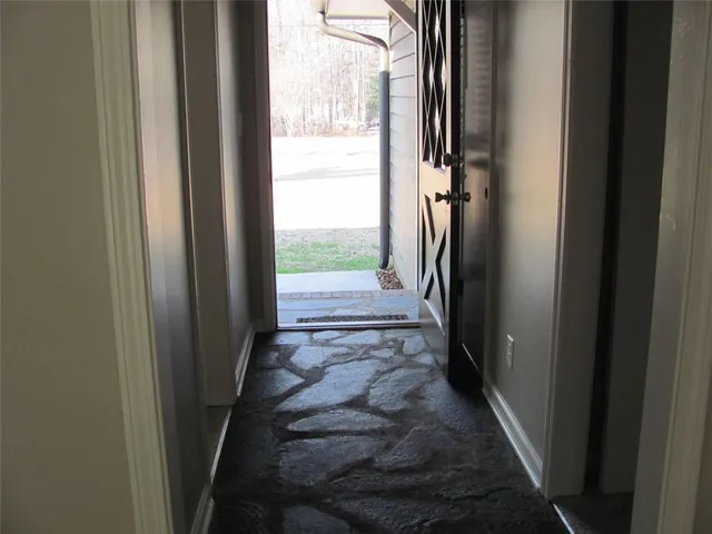a white toilet sitting next to a bath tub