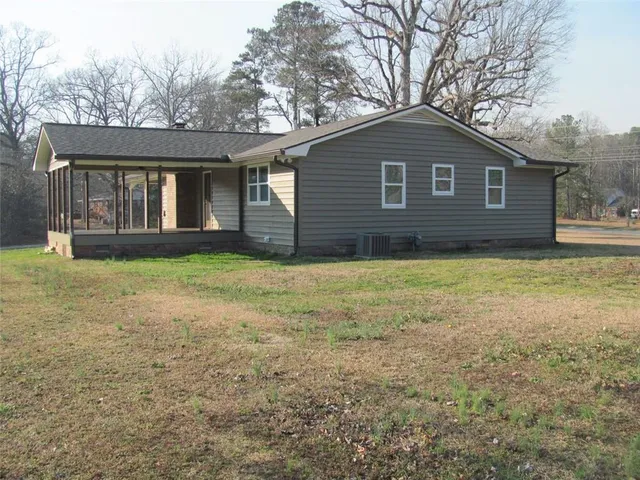 a view of a house with yard and a garden