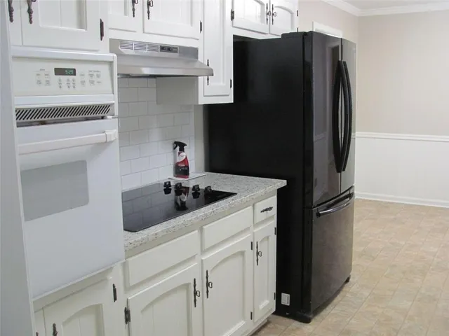 a kitchen with a refrigerator and a sink