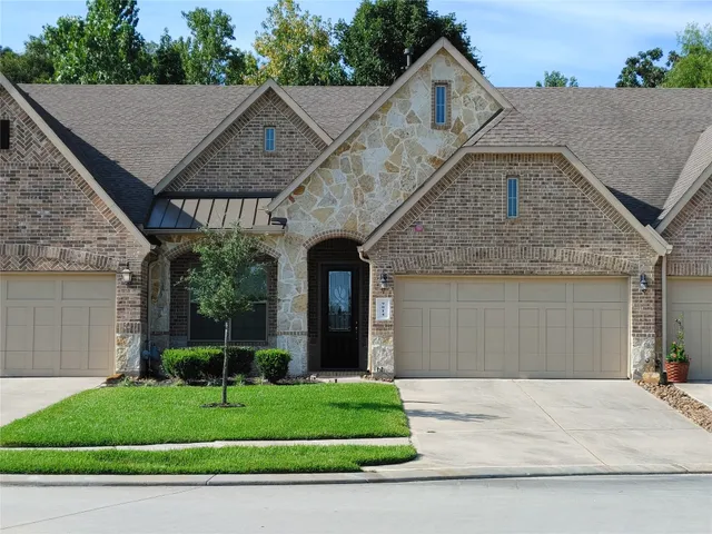 a front view of a house with a garden and plants