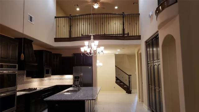 a kitchen with refrigerator and cabinets