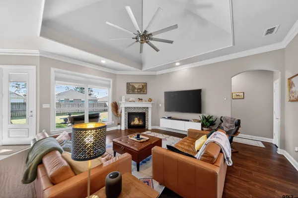a living room with furniture a fireplace and a flat screen tv