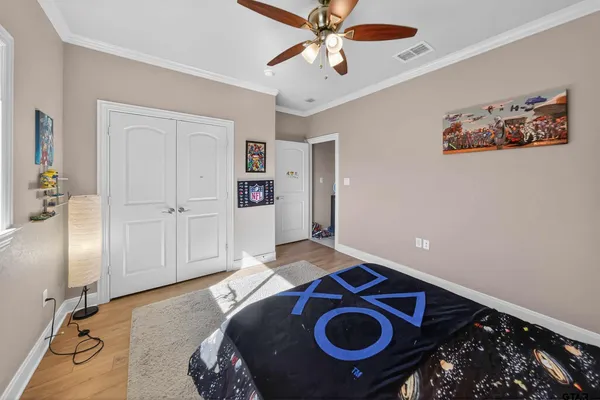 a bedroom with a bed and a chandelier