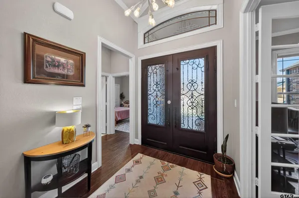 a bedroom with a bed and a flat tv screen on dresser