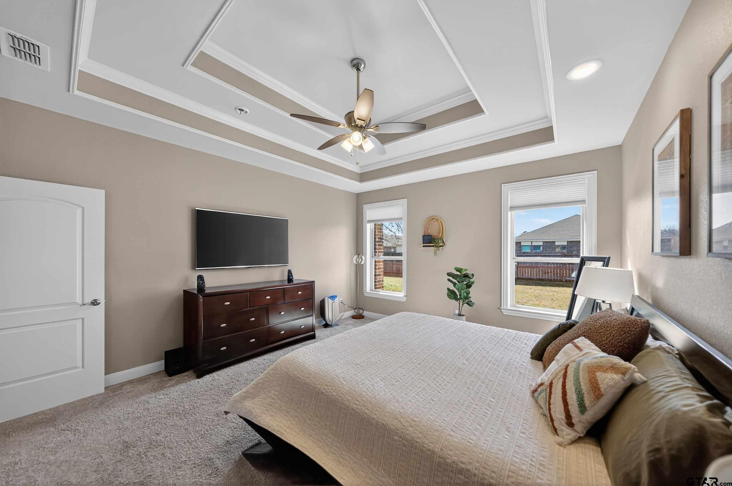 2202 Rana Park Flint, TX 75762 - Photo 26 of 47 a bedroom with a bed and a flat tv screen on dresser